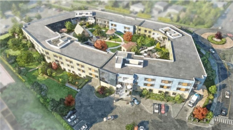 Aerial rendering of a large circular care facility situated on a green field.