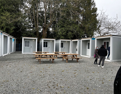 Sleeping units with four picnic tables positioned in front.