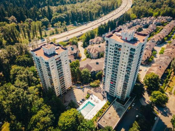 Two tall apartment towers loom over Highway No. 1 in Burnaby.