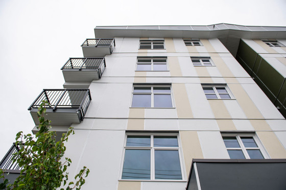 Upward view from below of a multi-storey apartment building.