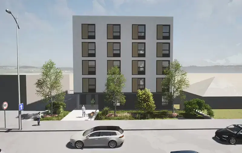Artist rendering of a four-storey housing building with trees, sidewalk, and cars along a city street.