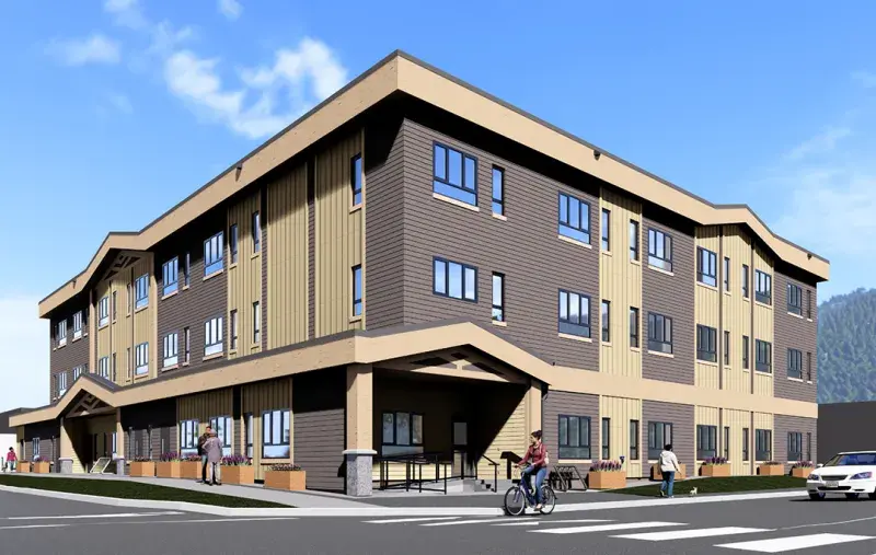 Rendering of a modern three‑storey building with tan and brown siding under a bright blue sky.