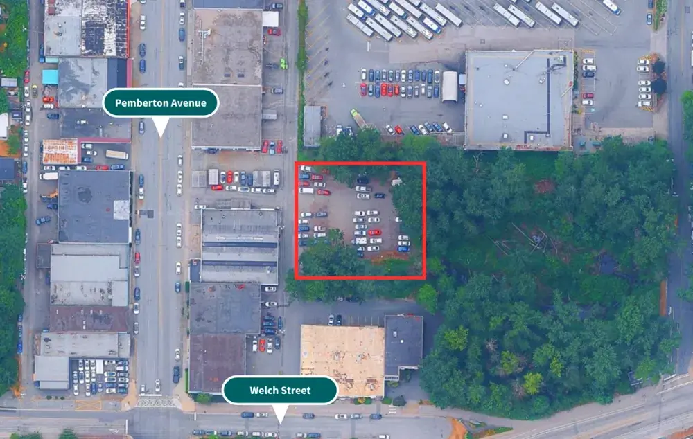 Aerial view of a city block with Pemberton Avenue and Welch Street labeled, highlighting a parking lot beside trees.