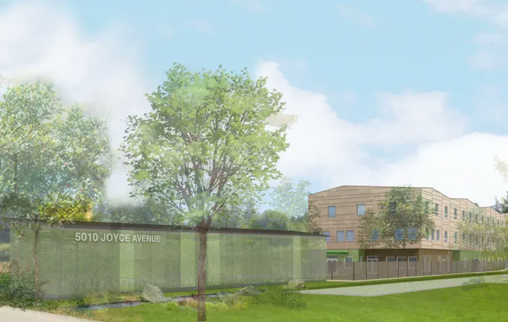 Architectural rendering of a landscaped development at 5010 Joyce Avenue, showing a modern three-storey building behind mature trees, green space, pathways, and a fenced outdoor area under a blue sky with clouds.